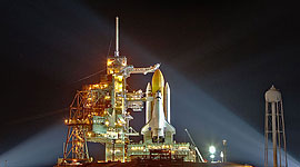 STS-133 space shuttle Discovery illuminated by Xenon lights on the launch pad
